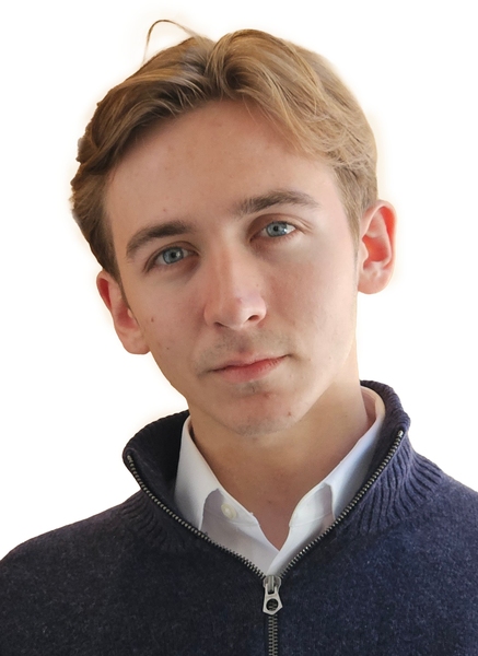 Headshot of a young man in a navy zip-up sweater against a plain white background.