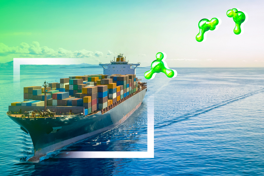 A container ship moving across open water with green hydrogen-themed graphics overlaid.