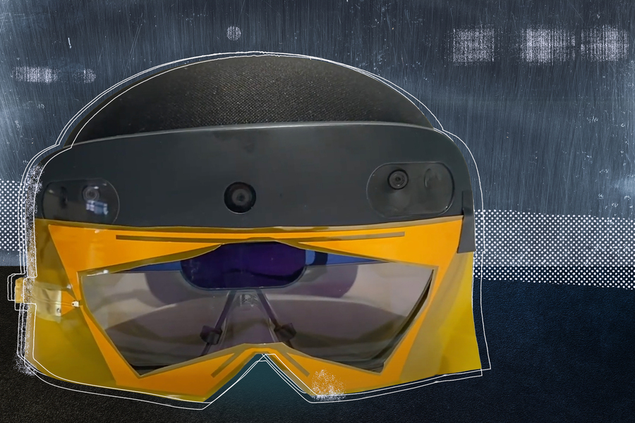 A mixed reality headset with yellow-framed protective lenses mounted on the front, photographed against a textured gray background with a white outline illustration overlay.