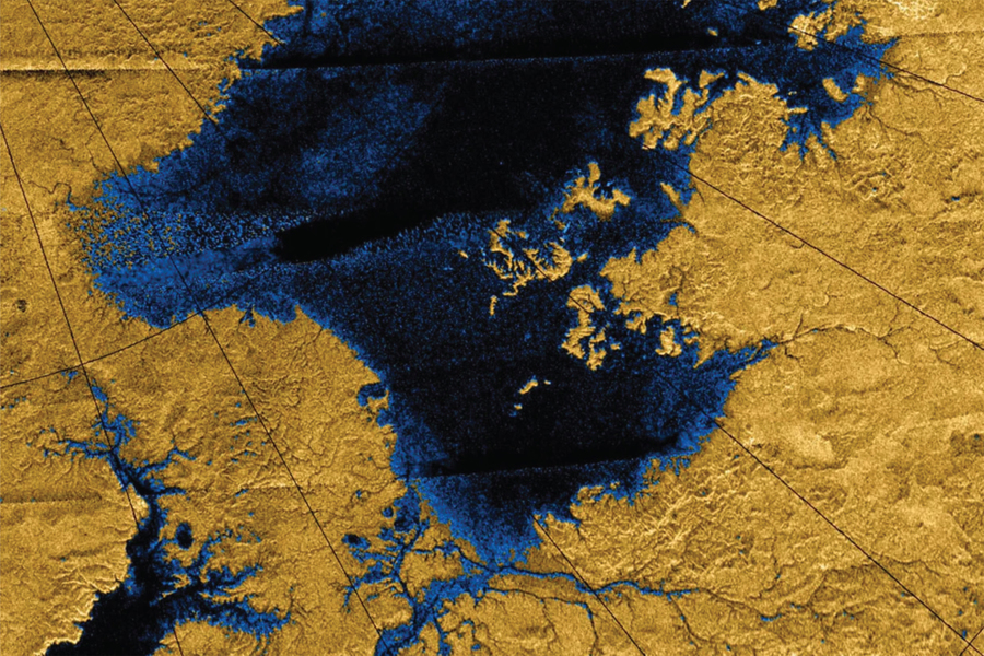 False-color radar image from orbit showing river networks and a large liquid hydrocarbon lake on Saturn's moon Titan, with blue channels cutting through golden terrain.