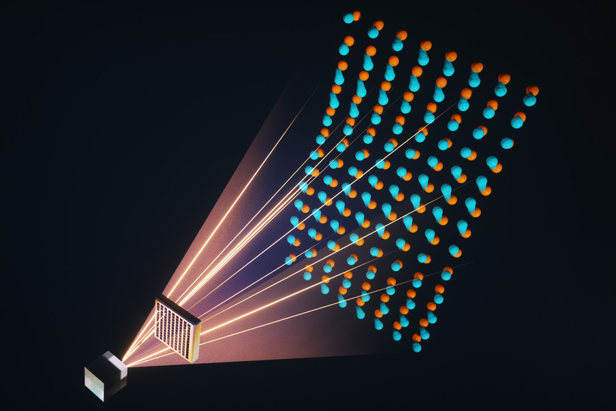 Illustration of laser beams projecting from a small chip onto a grid of paired orange and blue atom-like particles against a dark background, representing optical tweezer or quantum computing technology