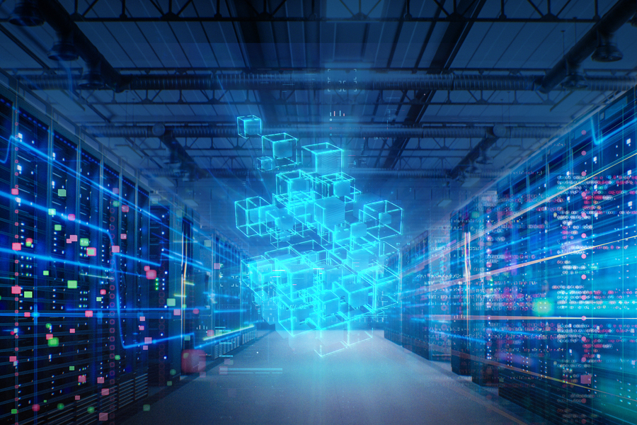 A digitally rendered data center corridor with rows of servers flanking a central glowing blue holographic cube structure.