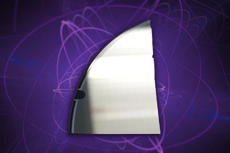 A curved silver mirror segment photographed against a purple background overlaid with glowing orbital path illustrations.